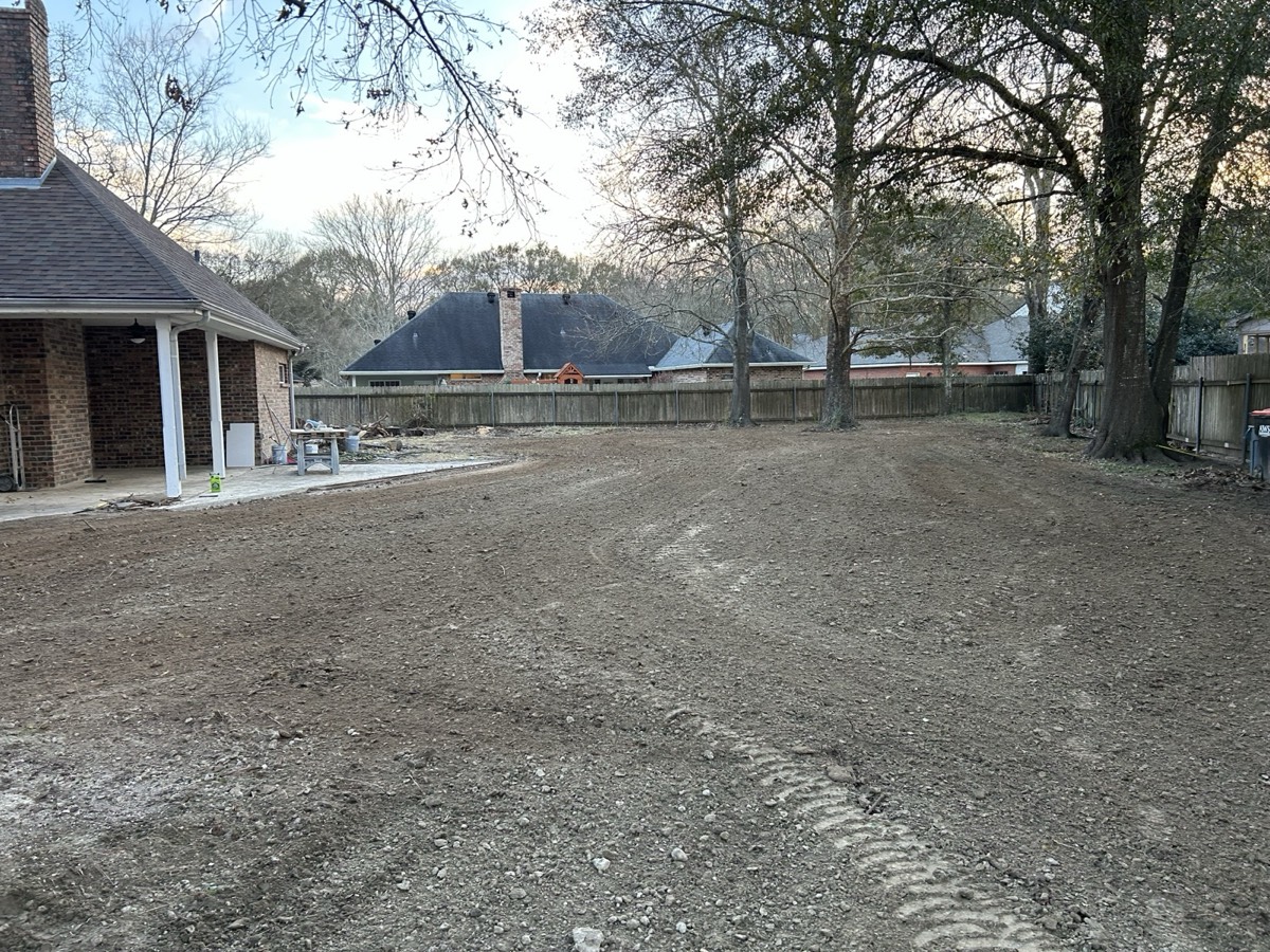 Backyard after pool removal — site graded and ready by Line & Grade Land Services