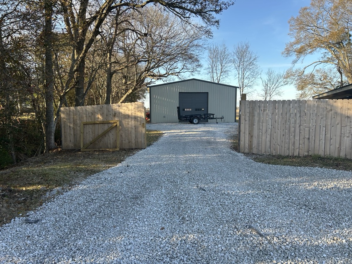 Completed gravel driveway with gate — driveway contractor in Lafayette, LA